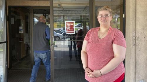 Brittany Plucas stands, Tuesday, May 9, 2023, outside the Hilltop Inn in Berlin, Vt., where she and her boyfriend have been staying since they became homeless in April 2023. Vermont’s pandemic-era expansion of the emergency housing program is ending soon and Plucas and her boyfriend will likely sleep in her car. (AP Photo/Lisa Rathke)