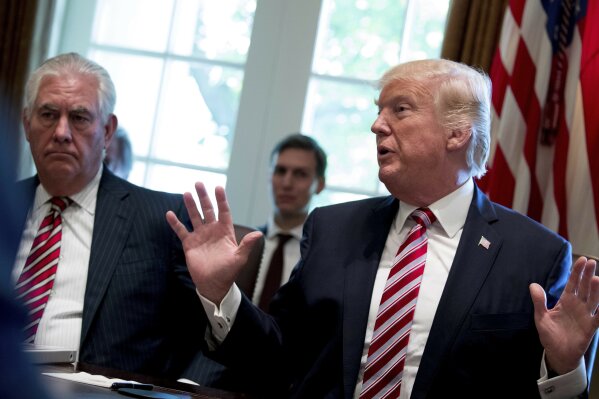 FILE - In this June 12, 2017, file photo, then-Secretary of State Rex Tillerson, left, and White House senior adviser Jared Kushner listen as President Donald Trump speaks during a Cabinet meeting in the Cabinet Room of the White House in Washington. Tillerson has told Congress that an awkward encounter with Kushner in a Washington restaurant was an example of diplomacy being conducted behind his back when he was in the administration. Tillerson told the House Foreign Affairs Committee he happened to be dining in the same restaurant while Kushner and Mexico's foreign secretary were having a private meal.(AP Photo/Andrew Harnik, File)