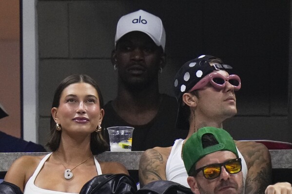 Miami Heat's Jimmy Butler, center top, Justin Bieber, alongside his wife Hailey Bieber, watch the third round of the U.S. Open tennis championships, Friday, Sept. 1, 2023, in New York. (AP Photo/Frank Franklin II)