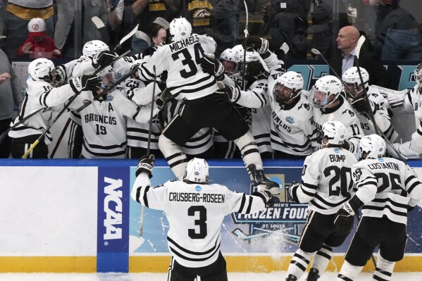 Western Michigan's Owen Michaels (34) is congratulated by teammates after scoring during the third period in the championship game of the NCAA Frozen Four men's college hockey tournament against the Boston University, Saturday, April 12, 2025, in St. Louis (AP Photo/Jeff Roberson)