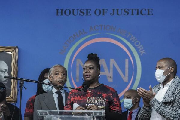 Rev. Al Sharpton, third from left, president of the National Action Network (NAN), and Mayor Eric Adams, far right, stand next to Sybrina Fulton, center, the mother of Trayvon Martin, as she address a rally commemorating the 10th anniversary of her son's killing, Saturday Feb. 26, 2022, at NAN's Harlem headquarters in New York. "Today is a bittersweet day," said Fulton, who with her family created the Trayvon Martin Foundation to raise awareness of gun violence. (AP Photo/Bebeto Matthews)