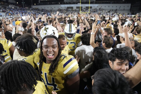 Georgia Tech fans swam the field after defeating North Carolina in an NCAA college football game, Saturday, Oct. 28, 2023, in Atlanta. (AP Photo/John Bzemore)