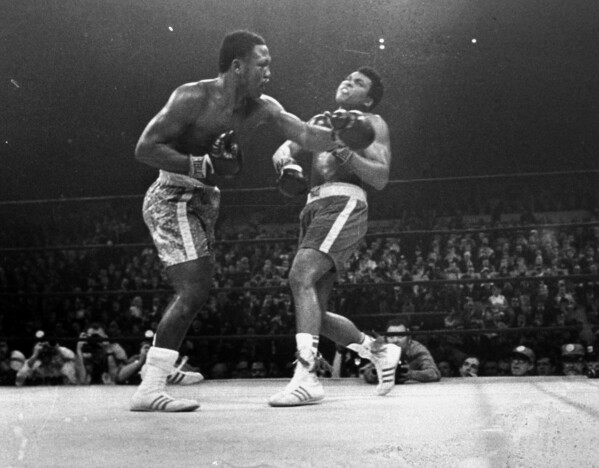 FILE - Joe Frazier hits Muhammad Ali with a left during the 15th round of their heavyweight title fight at New York's Madison Square Garden, in this March 8, 1971, file photo. (AP Photo/File)