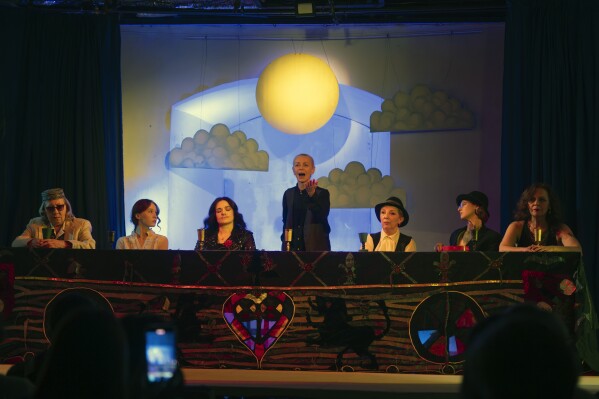 Actresses perform male roles on the stage of the Chernihiv Regional Youth Theater, which reinvented itself with an all-female cast, with most male actors at war, in Chernihiv, Ukraine, Sunday, Feb. 16, 2025. (AP Photo/Efrem Lukatsky)