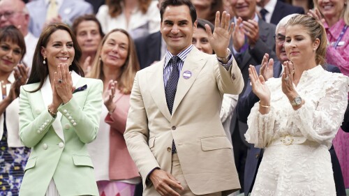 Britain's Kate, Princess of Wales, left, stands in the royal box with tennis champion Roger Federer and his wife Mirka, on day two of the Wimbledon tennis championships in London, Tuesday, July 4, 2023. (Adam Davy/PA via AP)