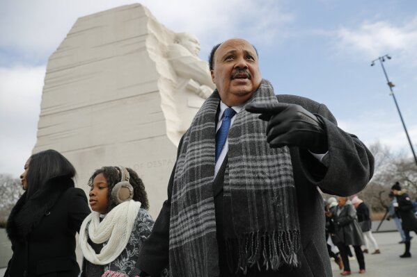 
              Martin Luther King III, right, with his wife Arndrea Waters, left, and their daughter Yolanda, 9, center, during their visit to the Martin Luther King Jr., Memorial on the National Mall in Washington, Monday, Jan. 15, 2018. The son of the late U.S. civil rights activist Martin Luther King Jr., and his family had earlier participated in an event commemorating the life and legacy of his father. (AP Photo/Pablo Martinez Monsivais)
            