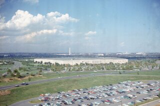 File-This undated file photo shows the Pentagon, headquarters of the U.S. Department of Defense, with the Washington Monument in background and a large parking lot in foreground, in Arlington, Va.  The Pentagon is proposing to end an arrangement in which a single military officer leads two of the nation's main cybersecurity organizations, a move that a leading Democrat said Saturday, Dec. 19, 2020, makes him “profoundly concerned” amid a large-scale cyberattack on U.S. government computer systems.  (AP Photo, File)