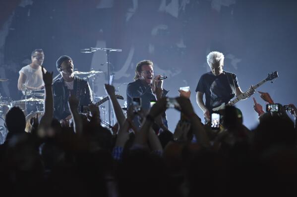 FILE - Larry Mullen Jr, left, The Edge, Bono and Adam Clayton of U2 perform during a concert at the Apollo Theater hosted by SiriusXM on June 11, 2018, in New York. (Photo by Evan Agostini/Invision/AP, File)