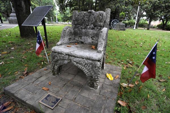 FILE - A monument to Confederate President Jefferson Davis is shown at a cemetery in Selma, Ala., on Wednesday, June 2, 2021. Three people were charged earlier this following the disappearance of the chair, which was recovered in New Orleans and is now glued down. Prosecutors in Louisiana have dropped the case, but an Alabama district attorney said on Wednesday, Oct. 20, that he will pursue the case against a man charged there. (AP Photo/Jay Reeves, File)