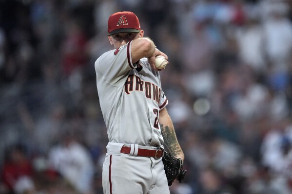 Arizona Diamondbacks starting pitcher Zach Davies (27) waits on the mound for manager Torey Lovullo to relieve him in the fourth inning of a baseball game against the Atlanta Braves Tuesday, July 18, 2023, in Atlanta. (AP Photo/John Bazemore)