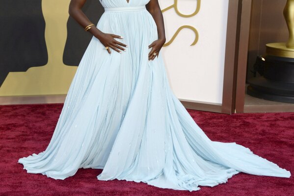 FILE - In this March 2, 2014 file photo, Lupita Nyong'o arrives at the Oscars in Los Angeles. Nyong'o, wearing a light blue Prada gown, won the Oscar for best supporting actress for her role in "12 Years a Slave." (Photo by Jordan Strauss/Invision/AP, File)