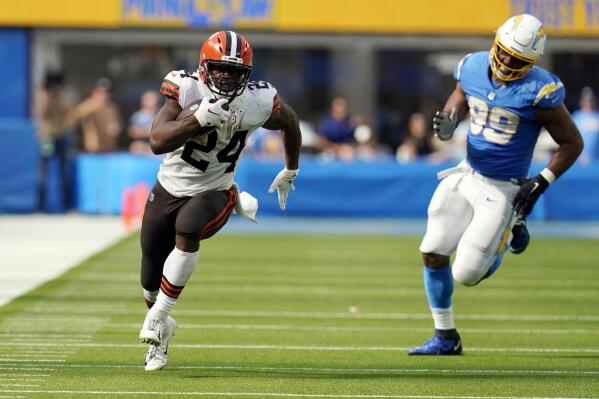Cleveland Browns running back Nick Chubb (24) runs for a touchdown past Los Angeles Chargers defensive tackle Jerry Tillery (99) during the second half of an NFL football game Sunday, Oct. 10, 2021, in Inglewood, Calif. (AP Photo/Gregory Bull)