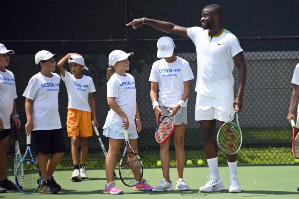 Tennis player Frances Tiafoe participates in a youth tennis clinic, Thursday, July 27, 2023, in College Park, Md. Tiafoe has launched a charitable fund in conjunction with the USTA Foundation with grants totaling $250,000. (AP Photo/Nick Wass)