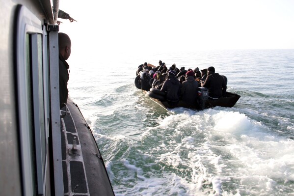 FILE - Migrants, mainly from sub-Saharan Africa, are stopped by Tunisian Maritime National Guard at sea during an attempt to get to Italy, near the coast of Sfax, Tunisia, on April 18, 2023. Tens of thousands of migrants are trapped in an increasingly violent limbo in camps In Tunisia, blocked from reaching Europe but too poor to go home, and facing backlash from local residents. (AP Photo, File)