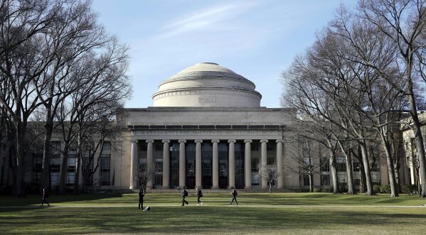 FILE - In this April 3, 2017 file photo, students walk past the "Great Dome" atop Building 10 on the Massachusetts Institute of Technology campus in Cambridge, Mass. MIT said Media Lab director Joi Ito resigned Saturday, Sept. 7, 2019, after reports he had a more extensive fundraising relationship with disgraced financier Jeffrey Epstein than previously acknowledged. (AP Photo/Charles Krupa, File)