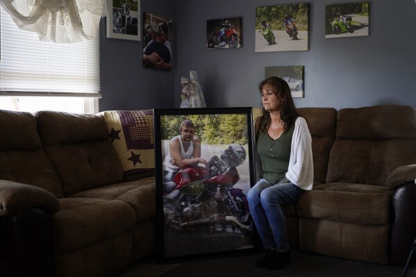 Karen Goodwin holds a photograph of her son, Austin Hunter Turner, Friday, Sept. 22, 2023, in Bristol, Tenn. Turner died in 2017, at the age of 23, after an encounter with the Bristol Police Department. Goodwin and her husband and kids had always admired paramedics and police. But in body-camera videos, from the moment police arrived, Hunter was treated as a suspect resisting arrest – not as a patient who was having a seizure. (AP Photo/George Walker IV)