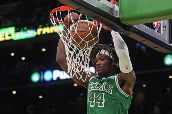 Boston Celtics center Robert Williams III (44) slams a dunk agains the Miami Heat during the first half of an NBA basketball game, Monday, Jan. 31, 2022, in Boston. (AP Photo/Charles Krupa)