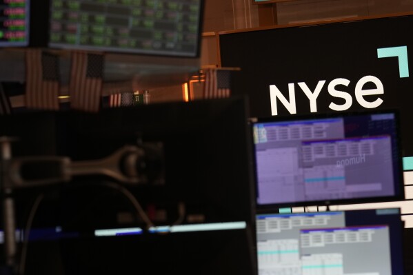 FILE - A screen displays the NYSE logo on the floor at the New York Stock Exchange in New York, Friday, June 2, 2023. (AP Photo/Seth Wenig, File)
