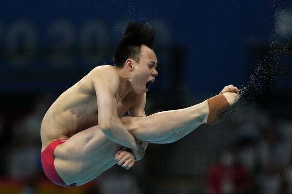 Xie Siyi of China competes in men's diving 3m springboard final at the Tokyo Aquatics Centre at the 2020 Summer Olympics, Tuesday, Aug. 3, 2021, in Tokyo, Japan. (AP Photo/Dmitri Lovetsky)