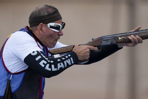 FILE - Venezuela's Leonel Martinez competes in the men's shooting trap final at the Pan American Games in Santiago, Chile, Oct. 27, 2023. Martinez was only 20 years old when he took part in the Los Angeles Games in 1984, but says he’s in better shape now, at 60, as he prepares to compete in Paris after the second-longest gap between Olympic appearances in history. (AP Photo/Moises Castillo, File)