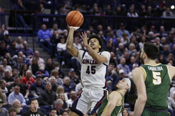 Gonzaga guard Rasir Bolton (45) shoots while defended by San Francisco guard Tyrell Roberts during the second half of an NCAA college basketball game, Thursday, Feb. 9, 2023, in Spokane, Wash. (AP Photo/Young Kwak)