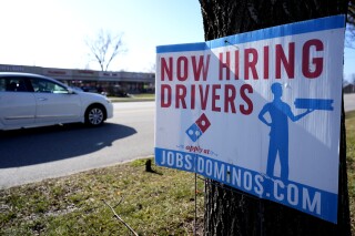 A hiring sign is posted outside of a Domino's restaurant in Wheeling, Ill., Monday, Jan. 29, 2024. On Tuesday, the Labor Department reports on job openings and labor turnover for December. (AP Photo/Nam Y. Huh)