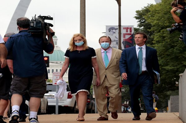 Mark and Patricia McCloskey and their attorney Joel Schwartz, right, leave court after a first appearance on felony weapons charges on Monday, Aug. 31, 2020, in St. Louis, Mo. The couple were charged in July with one felony count of unlawful use of a weapon — exhibiting, after they confronted protesters who were marching through their private street en route to Mayor Lyda Krewson's house in June. (Robert Cohen/St. Louis Post-Dispatch via AP)