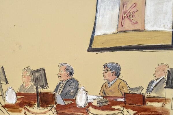
              In this courtroom artist's sketch, Keith Raniere, second from right, leader of the secretive group NXIVM, attends his trial in Brooklyn federal court, Tuesday, May 7, 2019 in New York. Above him is a screen with an image of a branding, containing his initials KR. A federal prosecutor says the self-help guru used threats, "shame and humiliation" while grooming women for sex. She also described how some female followers were branded with Raniere's initials. (Elizabeth Williams via AP)
            