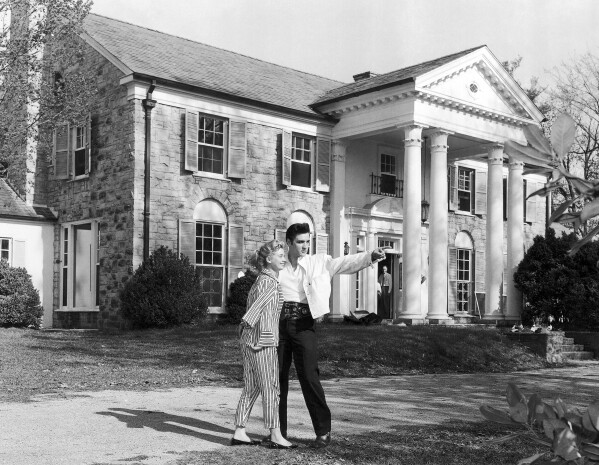 FILE - Elvis Presley with his girlfriend Yvonne Lime are photographed at his home, Graceland, in Memphis, Tenn., around 1957. A mysterious company has caused a stir for trying to auction Elvis Presley's Graceland in a foreclosure sale this week. A judge has blocked the sale after Presley's granddaughter filed a lawsuit alleging fraud. (AP Photo, File)