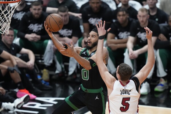 Boston Celtics forward Jayson Tatum (0) goes up for a shot against Miami Heat forward Nikola Jovic (5) during the first half of Game 3 of an NBA basketball first-round playoff series, Saturday, April 27, 2024, in Miami. (AP Photo/Wilfredo Lee)