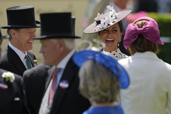 Kate, Duchess of Cambridge, second right, laughs as she stands in the paddock on the fourth day of the Royal Ascot horserace meeting, at Ascot Racecourse, in Ascot, England, Friday, June 17, 2022. Every June, Britain's royals, aristocrats and thousands of stylish guests don their finest headgear for Royal Ascot, a glamorous annual horse racing event that dates back to 1711, when Queen Anne founded Ascot Racecourse in Berkshire, southern England. (AP Photo/Alastair Grant)