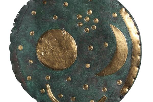This image courtesy of the State Office for Heritage Management and Archaeology Saxony-Anhalt shows the Nebra Sky Disc. The British Museum will display what it says is the world’s oldest surviving map of the stars in a major upcoming exhibition on the Stonehenge stone circle. The 3,600-year-old “Nebra Sky Disc,” first discovered in Germany in 1999, is one of the oldest surviving representations of the cosmos in the world and has never before been displayed in the U.K., the London museum said Monday. (Juraj Liptak/State Office for Heritage Management and Archaeology Saxony-Anhalt via AP)