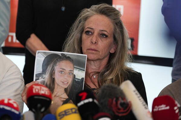 Keren, mother of Mia Schem and representatives of the families of the abducted and missing persons held by Hamas militants in Gaza hold a press conference following the release of a video by Hamas, in which the 21-year-old Israeli woman is seen. Schem was among the roughly 200 people kidnapped in Hamas' cross-border attack on Oct. 7. in Tel Aviv, Israel, Tuesday, Oct. 17, 2023. (AP Photo/Ohad Zwigenberg)