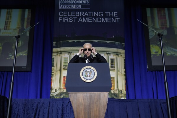 FILE - President Joe Biden puts on sunglasses after making a joke about becoming the "Dark Brandon" persona during the White House Correspondents' Association dinner at the Washington Hilton in Washington, April 29, 2023. Both presidential campaigns this year have embraced digital memes, the lingua franca of social media. (AP Photo/Carolyn Kaster, File)
