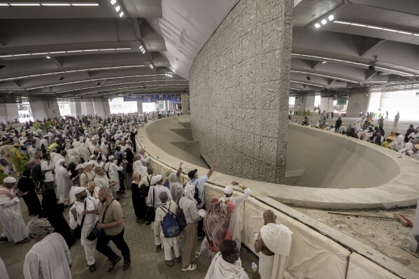 Pilgrims cast stones at a pillar in the symbolic stoning of the devil, the last rite of the annual Hajj pilgrimage, in Mina near the holly city of Mecca, Saudi Arabia, Thursday, June 29, 2023. (AP Photo/Amr Nabil)