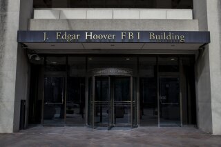 
              The J. Edgar Hoover FBI Building on Monday, March 4, 2019, in Washington. The FBI is stepping up its efforts to root out foreign corruption with a new squad of agents in Florida. The Miami-based squad begins later this month as part of the bureau’s international corruption unit. (AP Photo/Alex Brandon)
            
