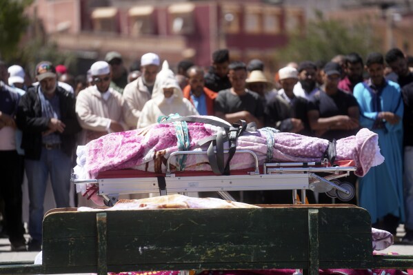 People observe a burial prayer for people who have been killed by the earthquake, in Moulay Brahim village, near Marrakech, Morocco, Saturday, Sept. 9, 2023. (AP Photo/Mosa'ab Elshamy)