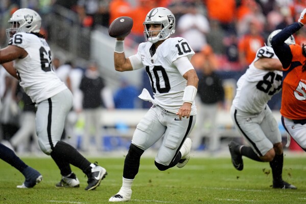 Las Vegas Raiders quarterback Jimmy Garoppolo (10) looks to pass against the Denver Broncos during the second half of an NFL football game, Sunday, Sept. 10, 2023, in Denver. (AP Photo/Jack Dempsey)