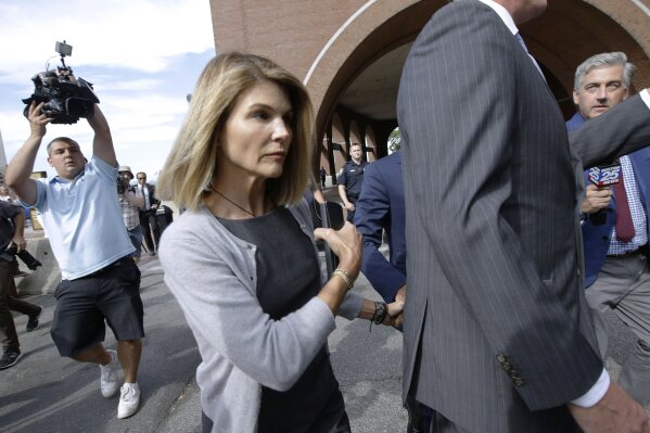 FILE - In this Aug. 27, 2019, file photo, actress Lori Loughlin departs federal court in Boston, after a hearing in a nationwide college admissions bribery scandal. Authorities say the “Full House” actress has reported to a federal prison in California to begin serving her two-month sentence for her role in the college admissions bribery scandal. The U.S. Attorney's office in Boston said Friday that Loughlin was being processed at the federal lockup in Dublin, California. (AP Photo/Steven Senne, File)