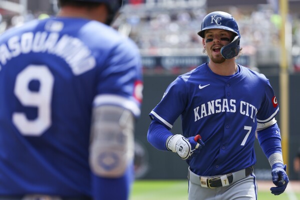 Kansas City Royals' Bobby Witt Jr., right, celebrates his solo home run with Vinnie Pasquantino, left, during the third inning of a baseball game against the Minnesota Twins, Wednesday, Aug. 14, 2024, in Minneapolis. (AP Photo/Matt Krohn)