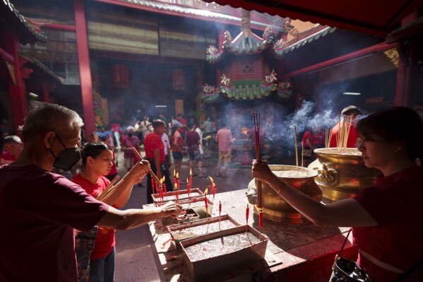 Malaysian ethnic Chinese pray on the first day of Lunar New Year's holidays at a temple in Kuala Lumpur, Malaysia Saturday, Feb. 10, 2024. The Chinese Lunar New Year falls on Feb. 10 this year, marking the start of the Year of the Dragon, according to the Chinese zodiac. (AP Photo/Vincent Thian)