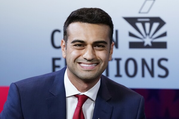 FILE - Then-Republican candidate for Arizona Attorney General, Abraham Hamadeh, smiles prior to a televised debate against Democrat Kris Mayes on Sept. 28, 2022. In a Truth Social post on Saturday night, 27, 2024, former President Donald Trump backed candidates Abraham Hamadeh and Blake Masters — former political allies turned bitter rivals — to represent Arizona’s conservative-leaning 8th Congressional District, praising the pair of Republicans as “two spectacular America First Candidates.” (AP Photo/Ross D. Franklin, File)