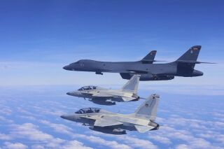 Two Philippine Air Force FA-50 fighter jets fly with two U.S. Air Force B-1 bomber aircraft during a joint patrol and training over the South China Sea on Tuesday, Feb.4, 2025.( Philippine Air Force via AP)