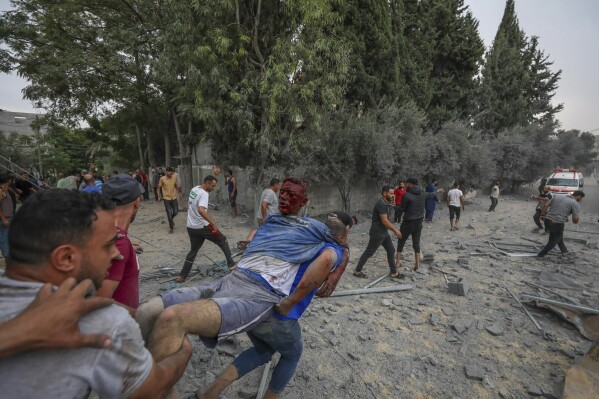 Palestinians evacuate a man wounded during an Israeli aerial bombardment of Jabaliya, near Gaza City, Wednesday, Oct. 11, 2023. (AP Photo/Mohammad Al Masri)