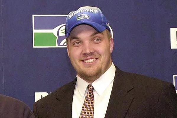FILE - Chris McIntosh smiles as the Seattle Seahawks first-round draft pick is shown during an introductory press conference in Kirkland, Washington, in this April 16, 2000, file photo. Chris McIntosh played for Barry Alvarez on two of Wisconsin’s Rose Bowl championship teams and spent the last few years working as his right-hand man. Now he is about to succeed his former coach and boss as the Badgers’ athletic director. Chancellor Rebecca Blank announced Wednesday, June 2, 2021, that McIntosh will take over when Alvarez finalizes his retirement. (AP Photo/Jay Drowns, File)