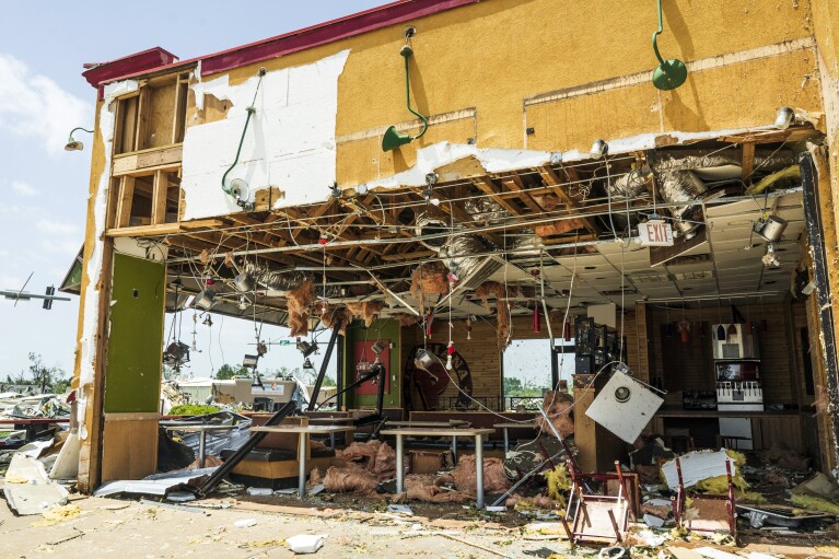 Storm damage occurs at a Popeyes in a shopping center at West Walnut Avenue and North 24th Street in Rogers, Arkansas, on Sunday, May 26, 2024. (Charlie Cajo/Northwest Arkansas Democrat-Gazette via The Associated Press)