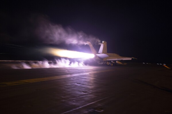 This image provided by the U.S. Navy shows an aircraft launching from USS Dwight D. Eisenhower (CVN 69) during flight operations in the Red Sea, Jan. 22, 2024. The United States and Britain struck 36 Houthi sites in Yemen on Saturday, Feb. 3, in a second wave of assaults meant to further disable Iran-backed groups in the region. (Kaitlin Watt/U.S. Navy via AP)