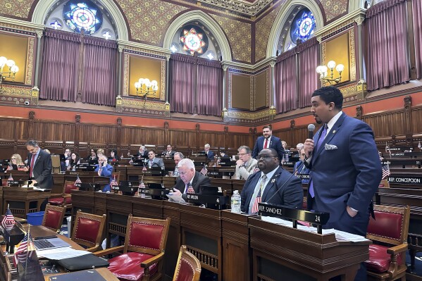 Connecticut state Rep. Manny Sanchez debates a bill in the House of Representatives chamber that would expand the state's current paid sick leave law, Wednesday, April 24, 2024 in Hartford, Conn. The bill would eventually require all employers to provide time off by 2027. (AP Photo/Susan Haigh)