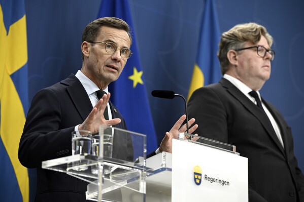 Sweden's Prime Minister Ulf Kristersson, left, and Minister of Justice Gunnar Strömmer attend a press conference after a meeting with National Police Chief Anders Thornberg, and Commander-in-Chief Micael Bydén in Stockholm, Sweden, Friday Sept. 29, 2023. Sweden’s prime minister said Friday the Swedish military can carry out some duties to free up police so it can focus on the unprecedented crime wave that has shocked the Scandinavian country with almost daily shootings and bombings. (Anders Wiklund/TT News Agency via AP)