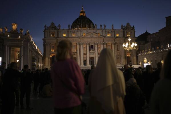 People gather in St Peter's Square as they wait to see the smoke billow from the chimney of the Sistine Chapel in St Peter's Square during the cardinals' conclave to elect a new pope, at the Vatican, Wednesday, May 7, 2025. (AP Photo/Francisco Seco)
